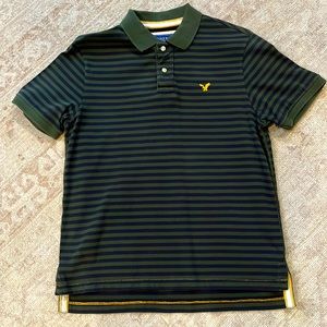 Green and blue stripe American Eagle short sleeve polo.  Gold monogrammed emblem